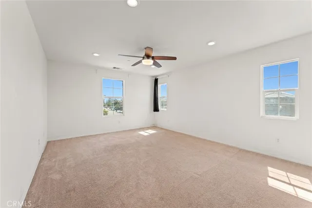 a view of a room with a ceiling fan