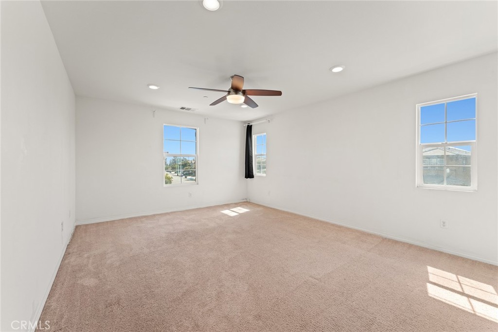 8022-8022 Sea Salt Avenue Fontana, CA 92336 - Photo 23 of 35 a view of a room with a ceiling fan