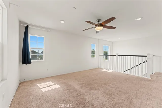 a view of a livingroom with a ceiling fan and window