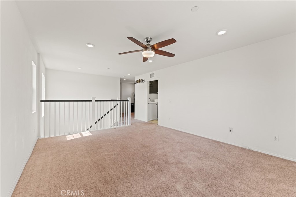8022-8022 Sea Salt Avenue Fontana, CA 92336 - Photo 25 of 35 a view of a hallway with a ceiling fan