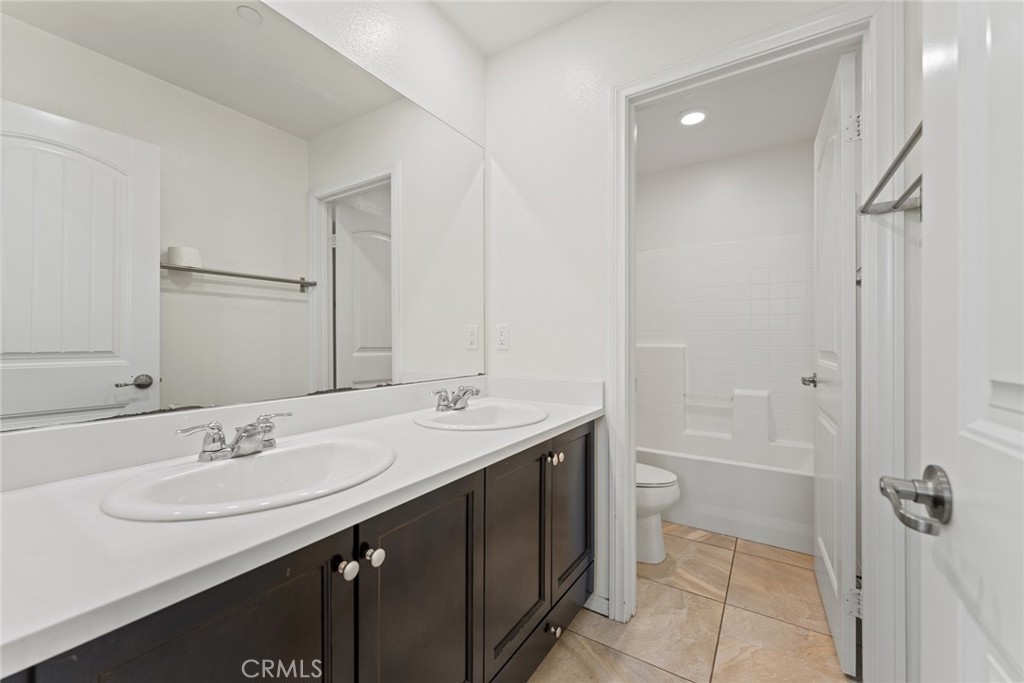 8022-8022 Sea Salt Avenue Fontana, CA 92336 - Photo 28 of 35 a bathroom with a sink a toilet and shower