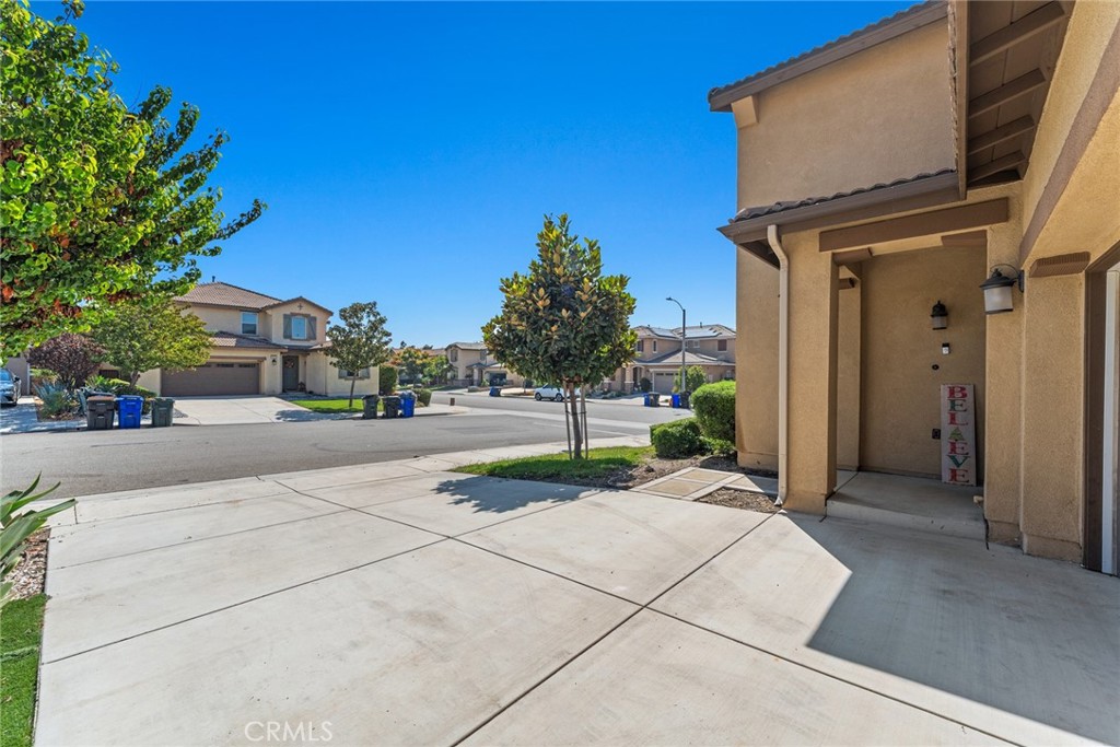8022-8022 Sea Salt Avenue Fontana, CA 92336 - Photo 4 of 35 a pathway of a house with a yard