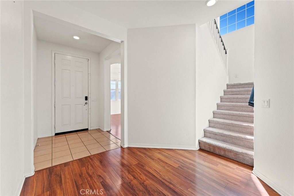 8022-8022 Sea Salt Avenue Fontana, CA 92336 - Photo 5 of 35 a view of an empty room with wooden floor