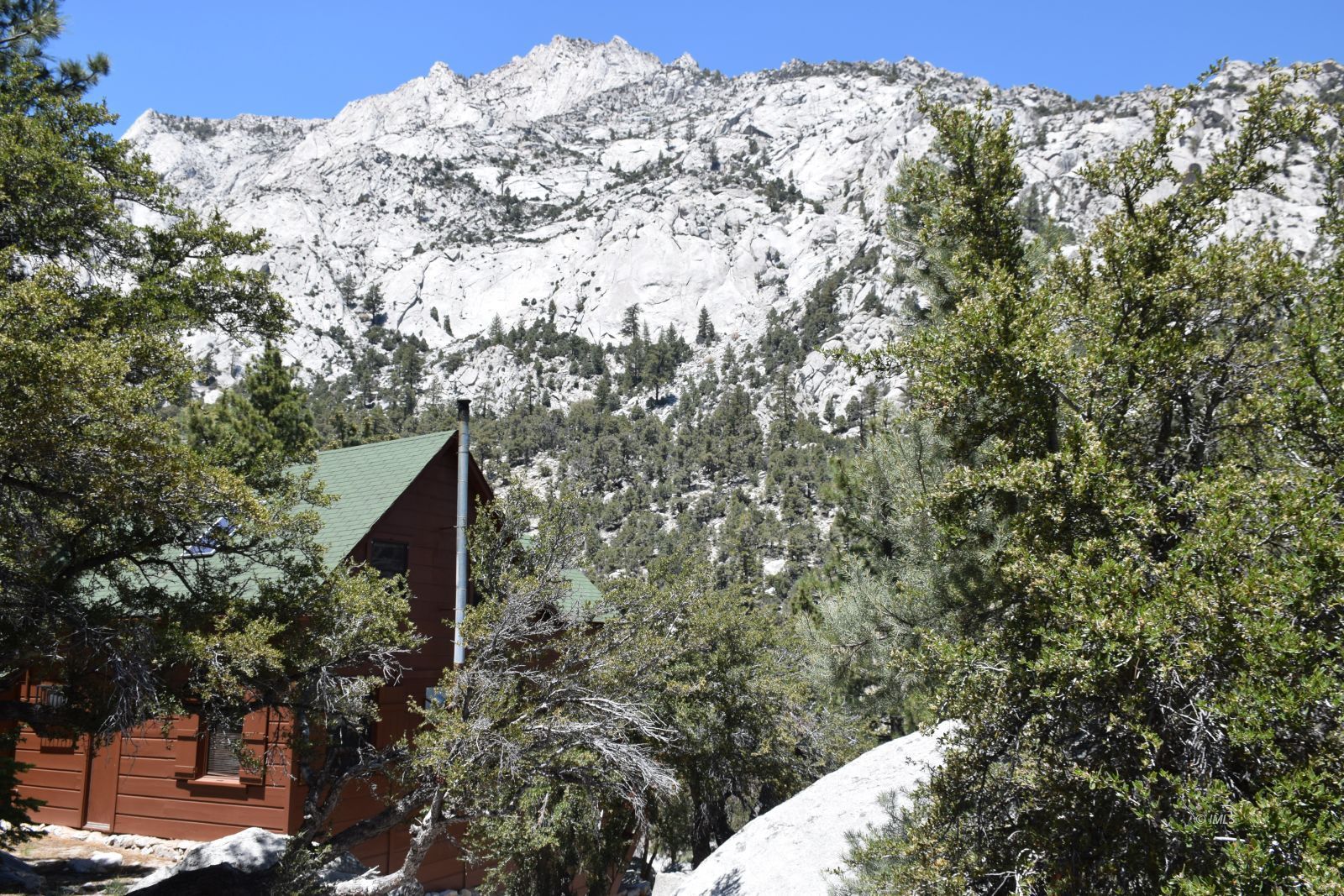 4 Whitney Portal Road Lone Pine, CA 93545 - Photo 5 of 20 a view of a wooden house with a mountain