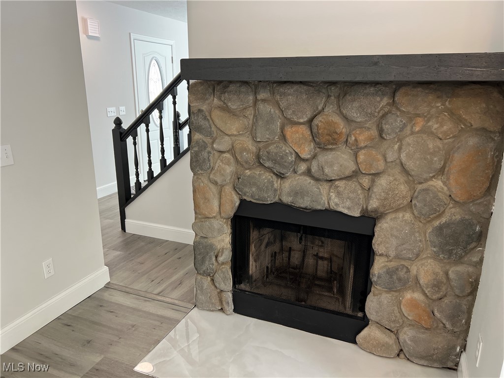 1279 Lander Road Cleveland, OH 44124 - Photo 22 of 37 Room details featuring a fireplace, baseboards, visible vents, and wood finished floors