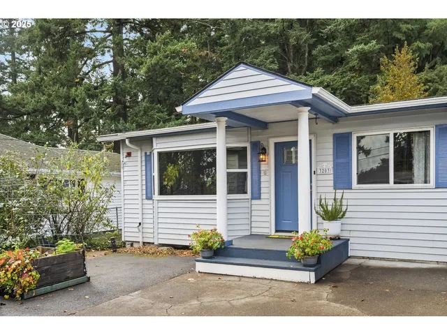 a front view of a house with a garden and outdoor seating