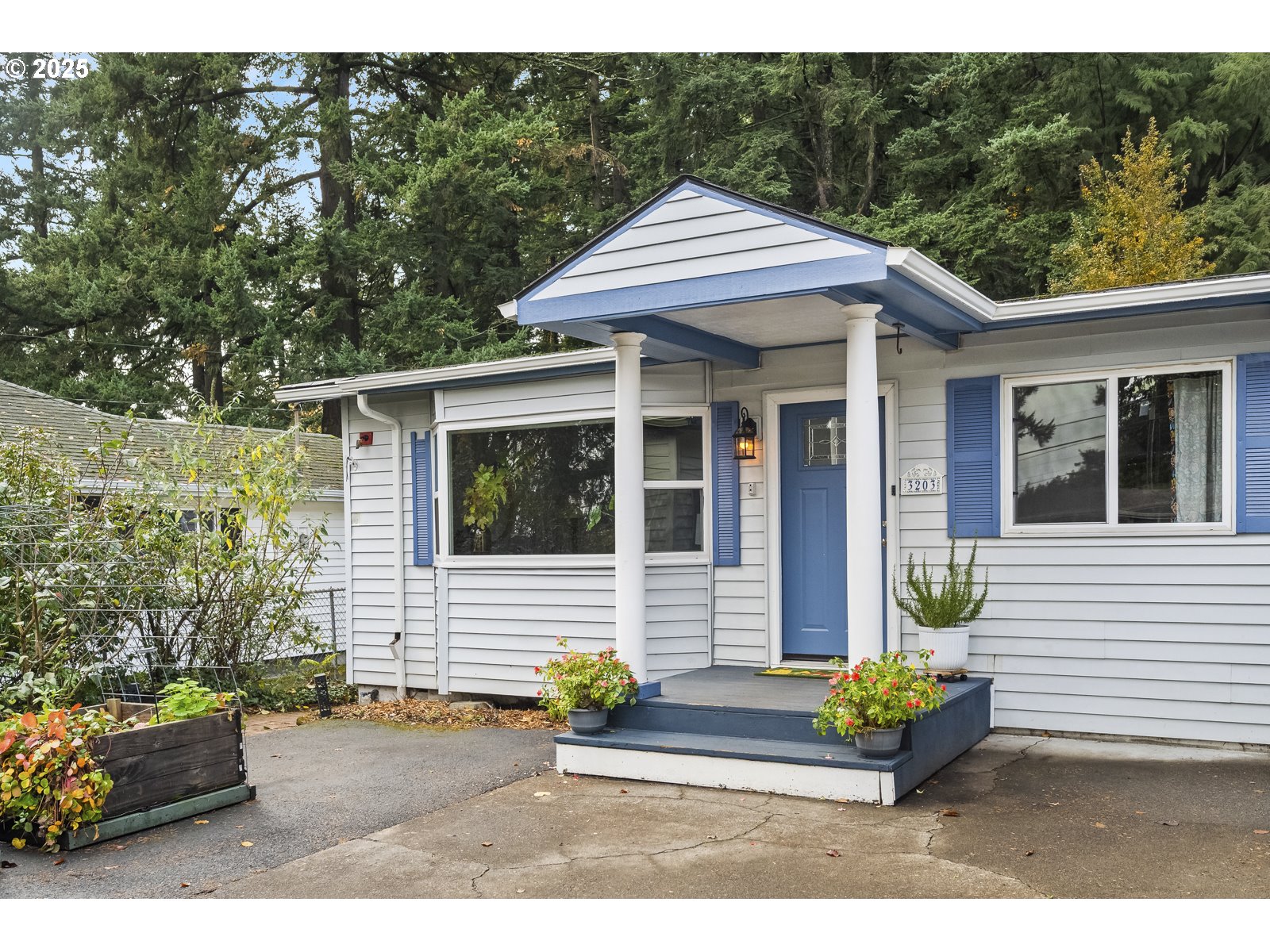 a front view of a house with a garden and outdoor seating