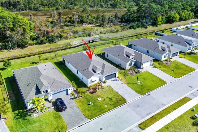 an aerial view of a house with a swimming pool