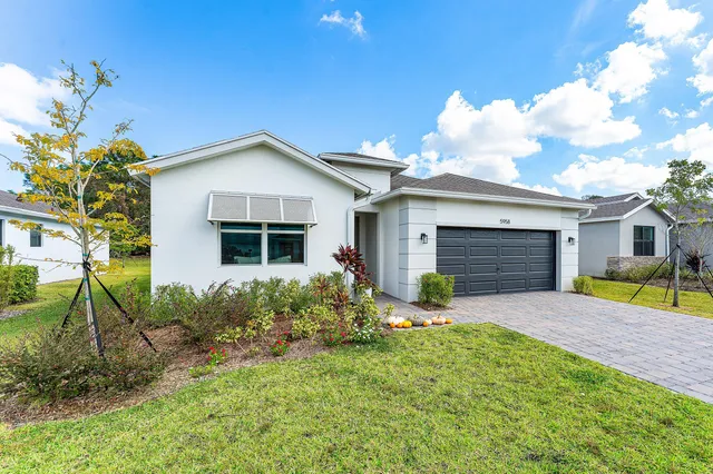 a front view of house with yard and outdoor seating