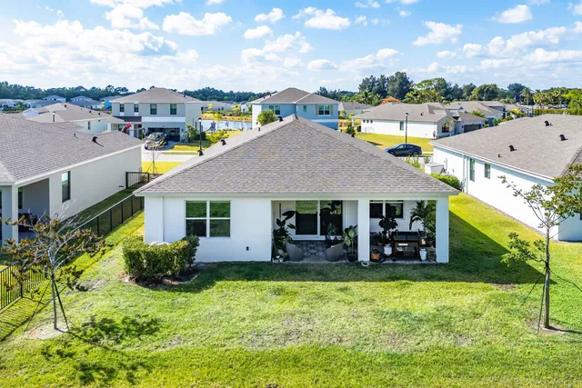 a aerial view of a house with swimming pool and a yard
