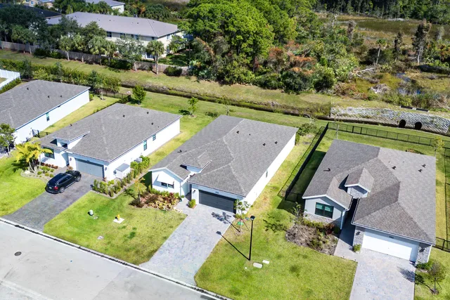 an aerial view of a house with a swimming pool yard and outdoor seating