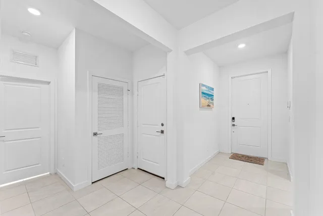 a kitchen with stainless steel appliances kitchen island granite countertop a sink a stove a dining table and chairs