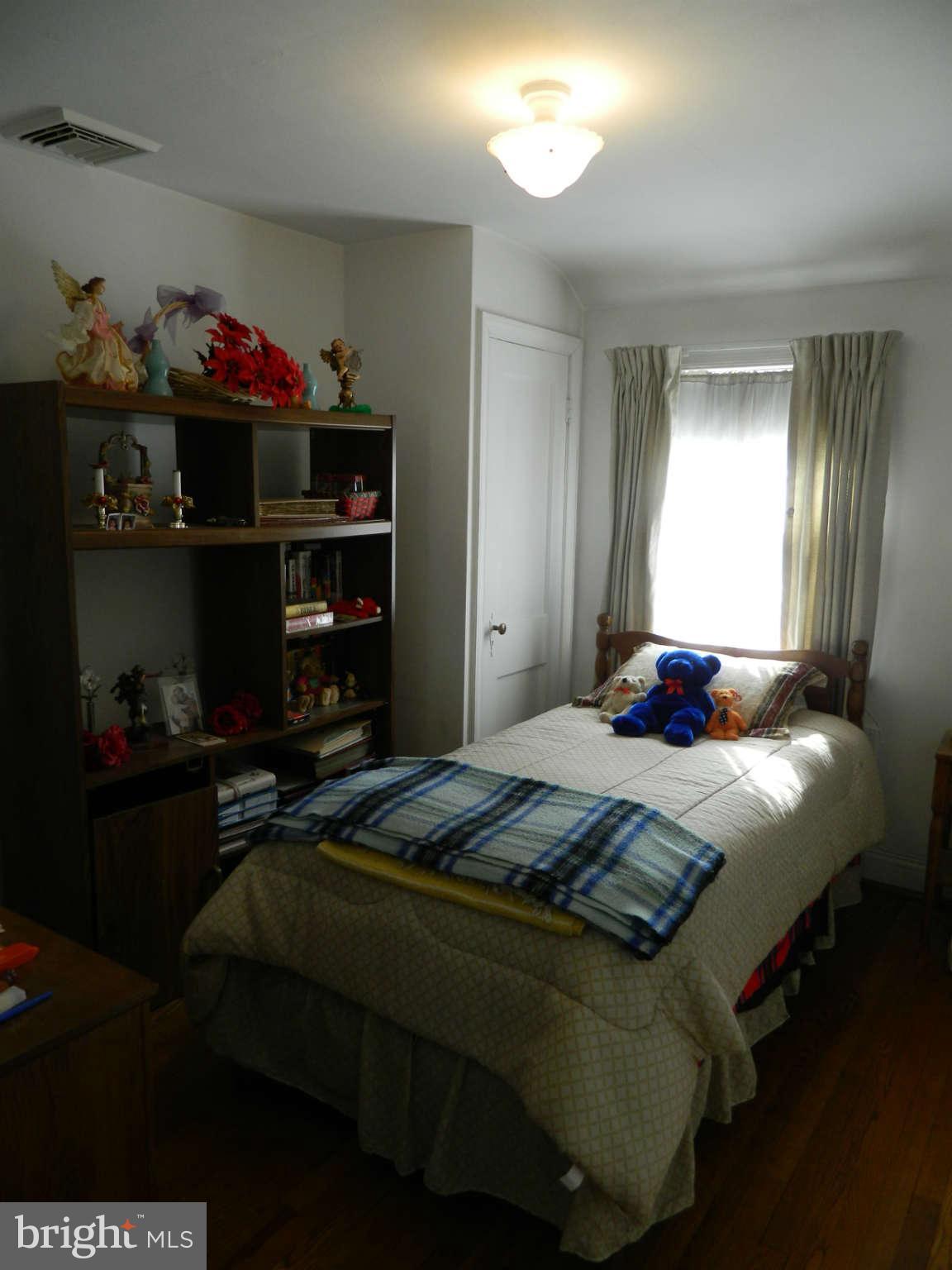 3834 Monterey Road Baltimore, MD 21218 - Photo 22 of 26 a bedroom with a bed and a window