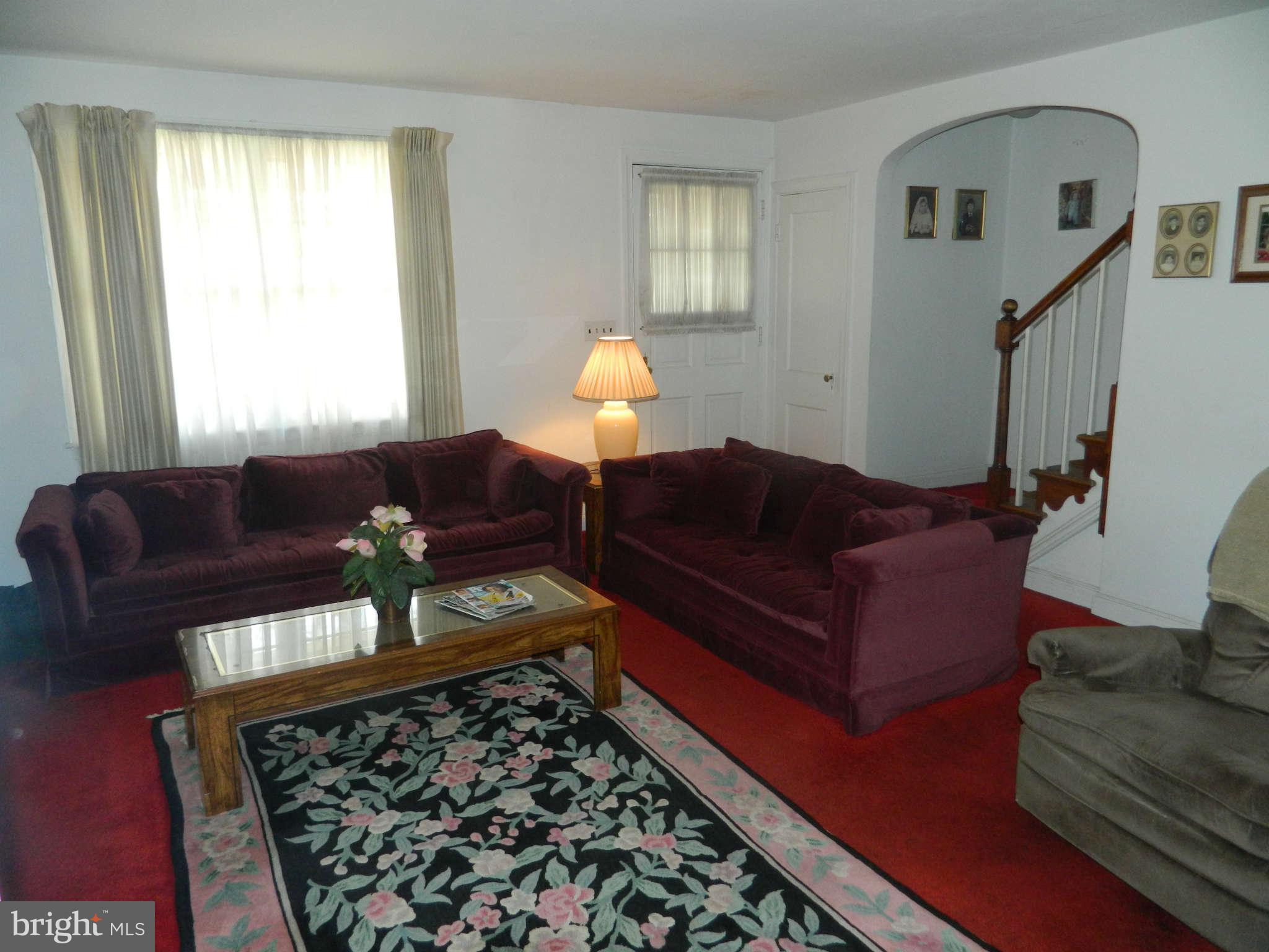 3834 Monterey Road Baltimore, MD 21218 - Photo 8 of 26 a living room with furniture and a rug
