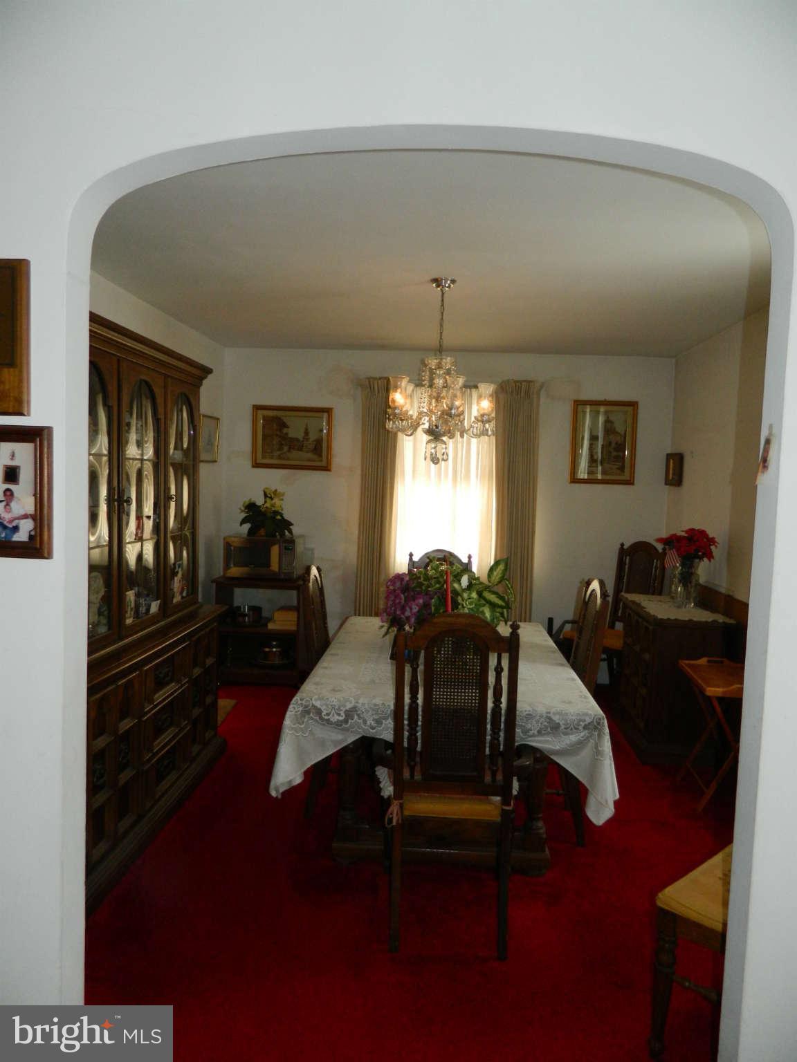 3834 Monterey Road Baltimore, MD 21218 - Photo 10 of 26 a living room with furniture and a chandelier