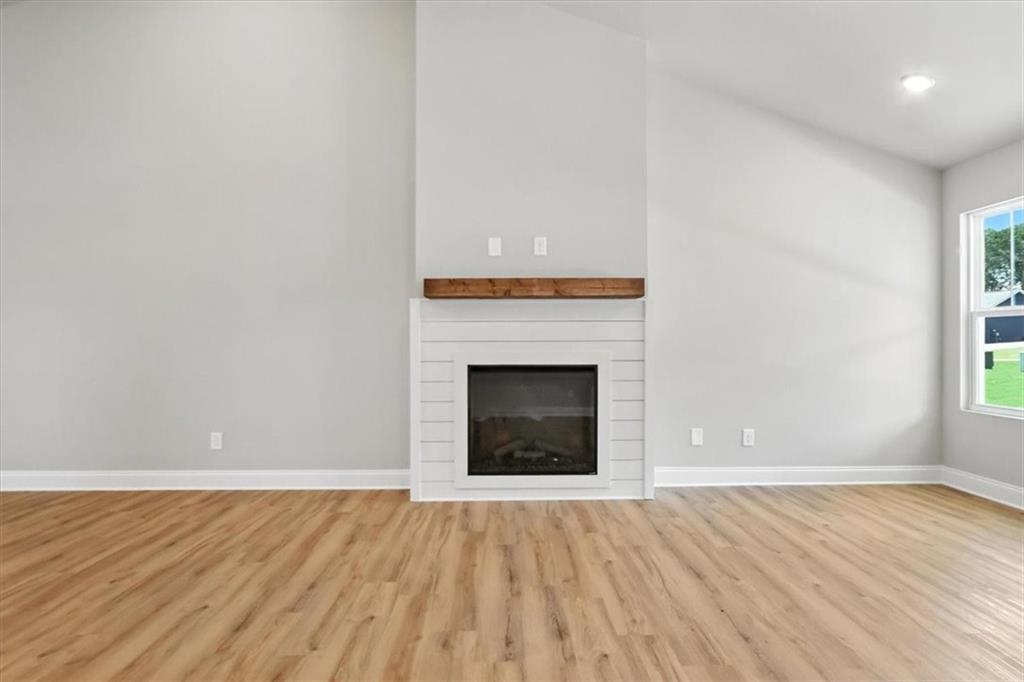 277 Rachel Lane Hartwell, GA 30643 - Photo 15 of 35 a view of an empty room with wooden floor and a fireplace