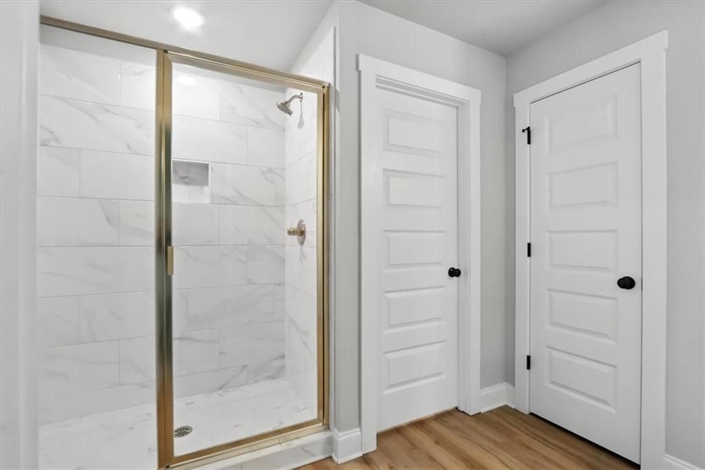 277 Rachel Lane Hartwell, GA 30643 - Photo 31 of 35 a bathroom with a shower and a glass door