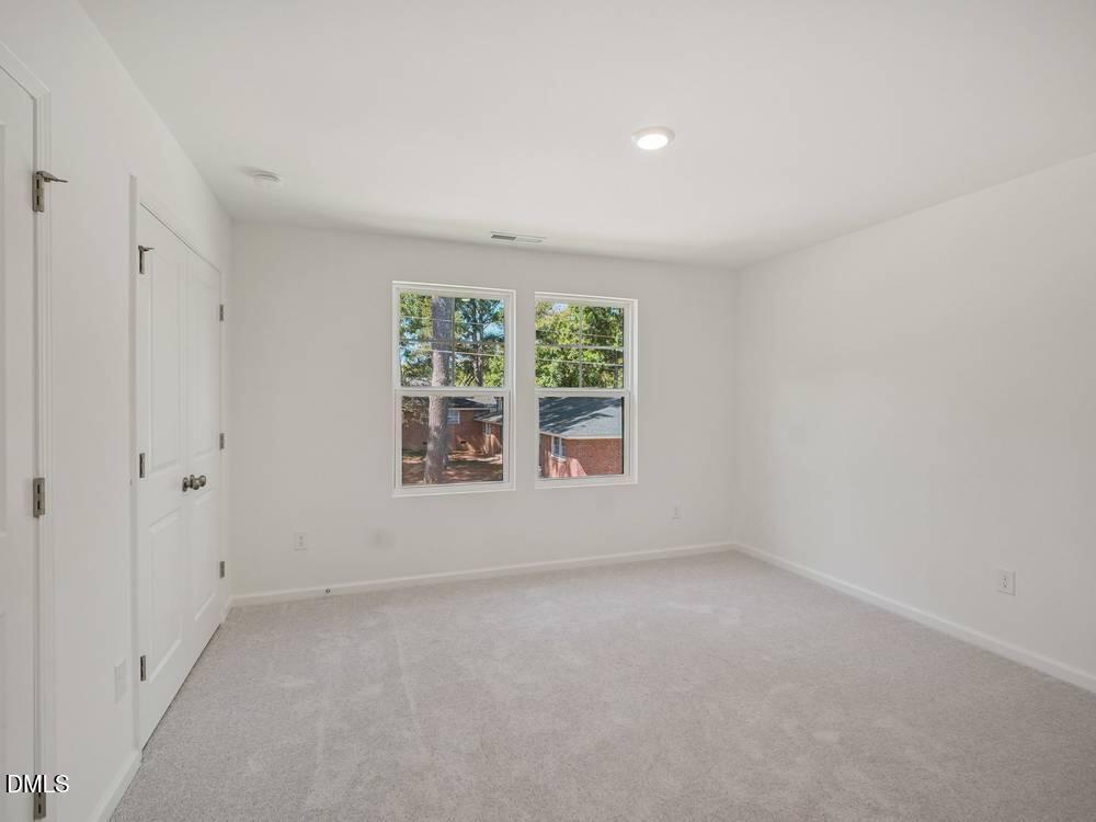 3101 White Blossom Court, Unit SAVANNAH 3109 Raleigh, NC 27610 - Photo 11 of 20 an empty room with windows