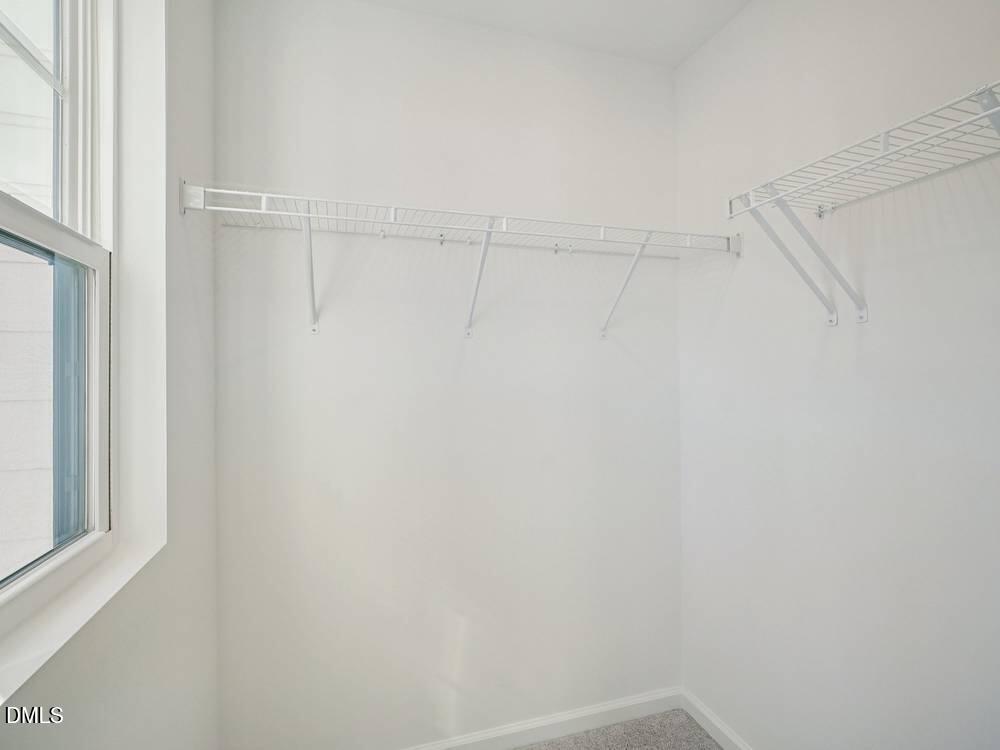 3101 White Blossom Court, Unit SAVANNAH 3109 Raleigh, NC 27610 - Photo 12 of 20 a view of a room with racks on the wall