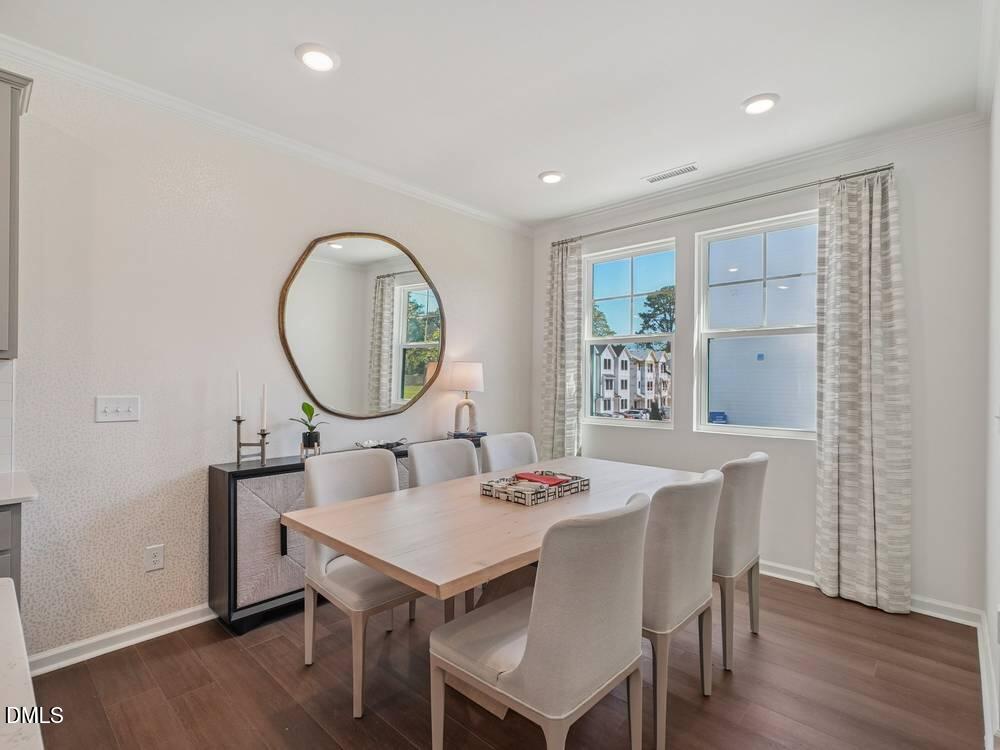 3101 White Blossom Court, Unit SAVANNAH 3109 Raleigh, NC 27610 - Photo 7 of 20 a view of a dining room with furniture window and wooden floor