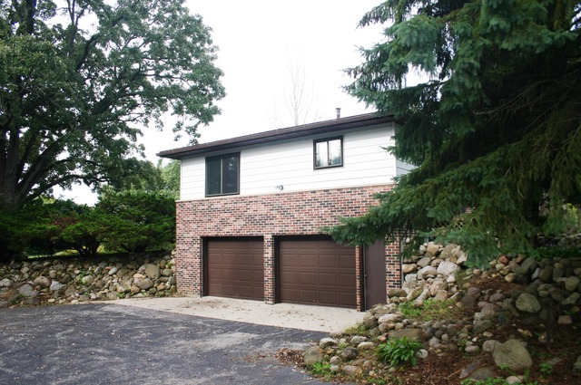 18108 Altenburg Road Harvard, IL 60033 - Photo 11 of 12 a front view of a house with a garden