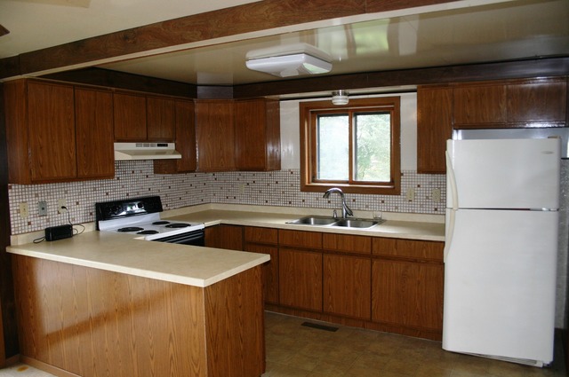 18108 Altenburg Road Harvard, IL 60033 - Photo 6 of 12 a kitchen with a sink a stove and a refrigerator