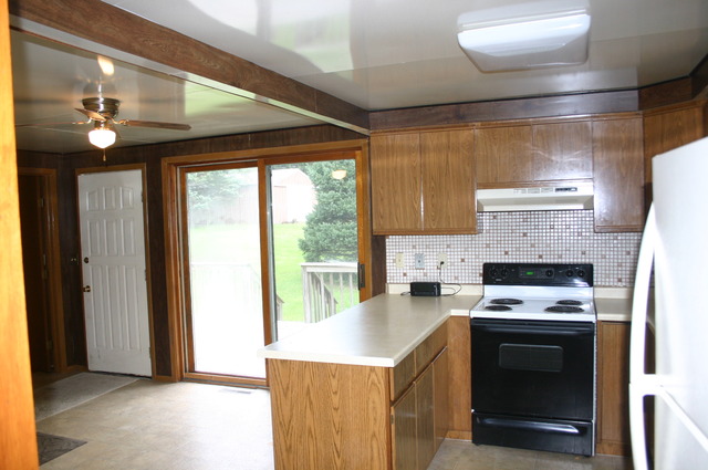 18108 Altenburg Road Harvard, IL 60033 - Photo 7 of 12 a kitchen with a stove a sink and a refrigerator