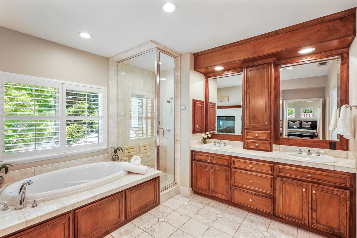5512 Riviera Granite Bay, CA 95746 - Photo 43 of 76 a spacious bathroom with a double vanity sink large mirror and a bathtub