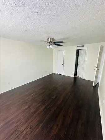 a view of a room with wooden floor