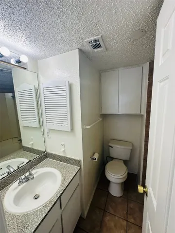 a bathroom with a sink toilet and mirror