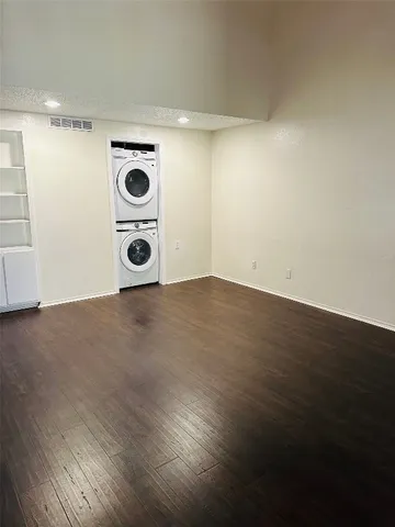 a view of an empty room and wooden floor
