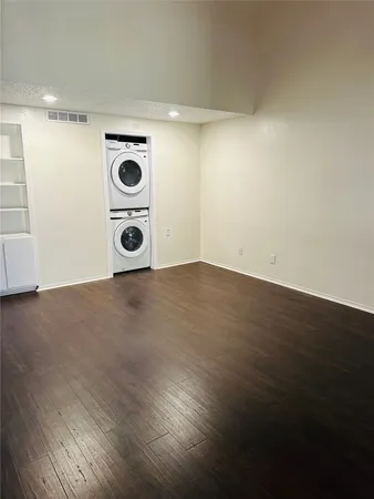a view of an empty room and wooden floor