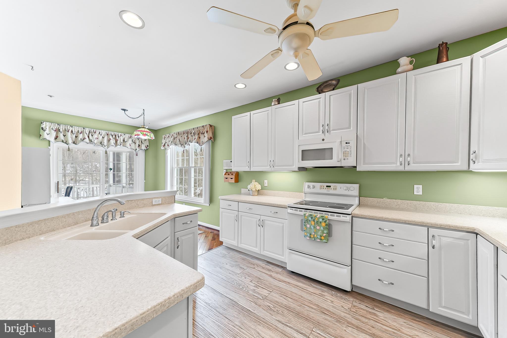 1299 Country Club Drive Springfield, PA 19064 - Photo 11 of 33 a kitchen with a sink window and cabinets