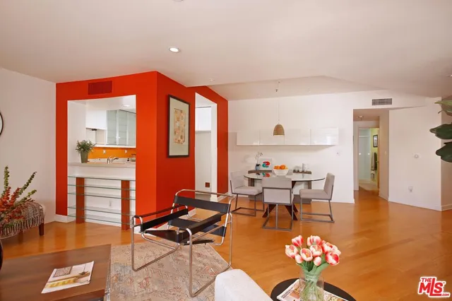a living room with furniture a rug and a floor to ceiling window