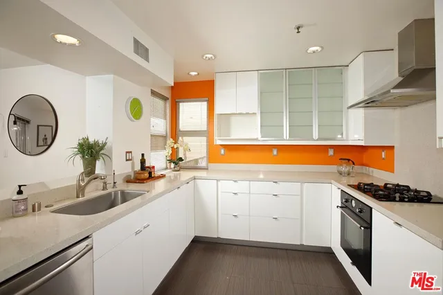 a kitchen with a sink cabinets and stainless steel appliances