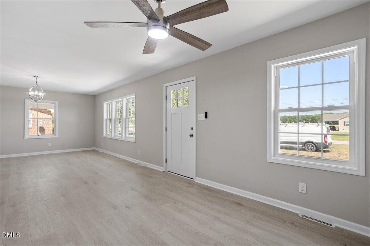 804 Little Rock Church Road Lucama, NC 27851 - Photo 14 of 28 a view of an empty room with a window and wooden floor