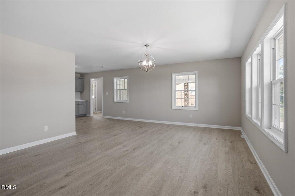 804 Little Rock Church Road Lucama, NC 27851 - Photo 16 of 28 an empty room with wooden floor and windows