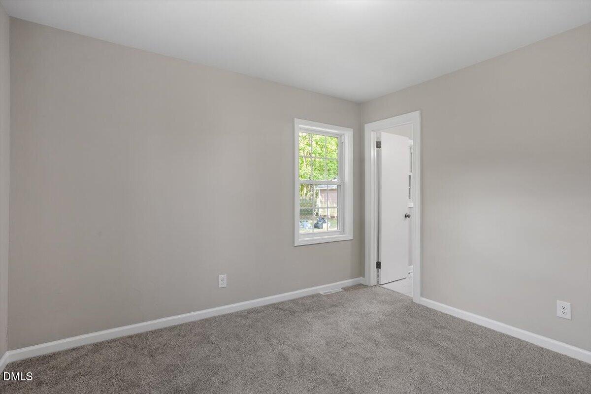 804 Little Rock Church Road Lucama, NC 27851 - Photo 19 of 28 an empty room with windows and closet