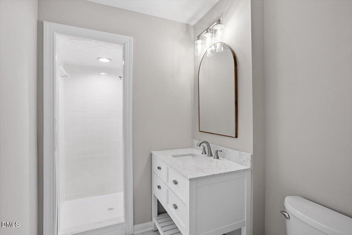 804 Little Rock Church Road Lucama, NC 27851 - Photo 20 of 28 a bathroom with a double vanity sink and mirror