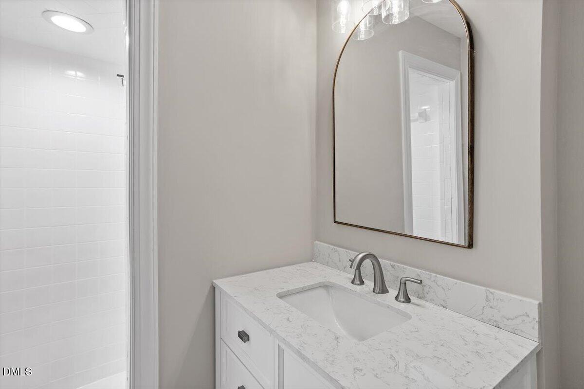 804 Little Rock Church Road Lucama, NC 27851 - Photo 21 of 28 a bathroom with a sink vanity and mirror