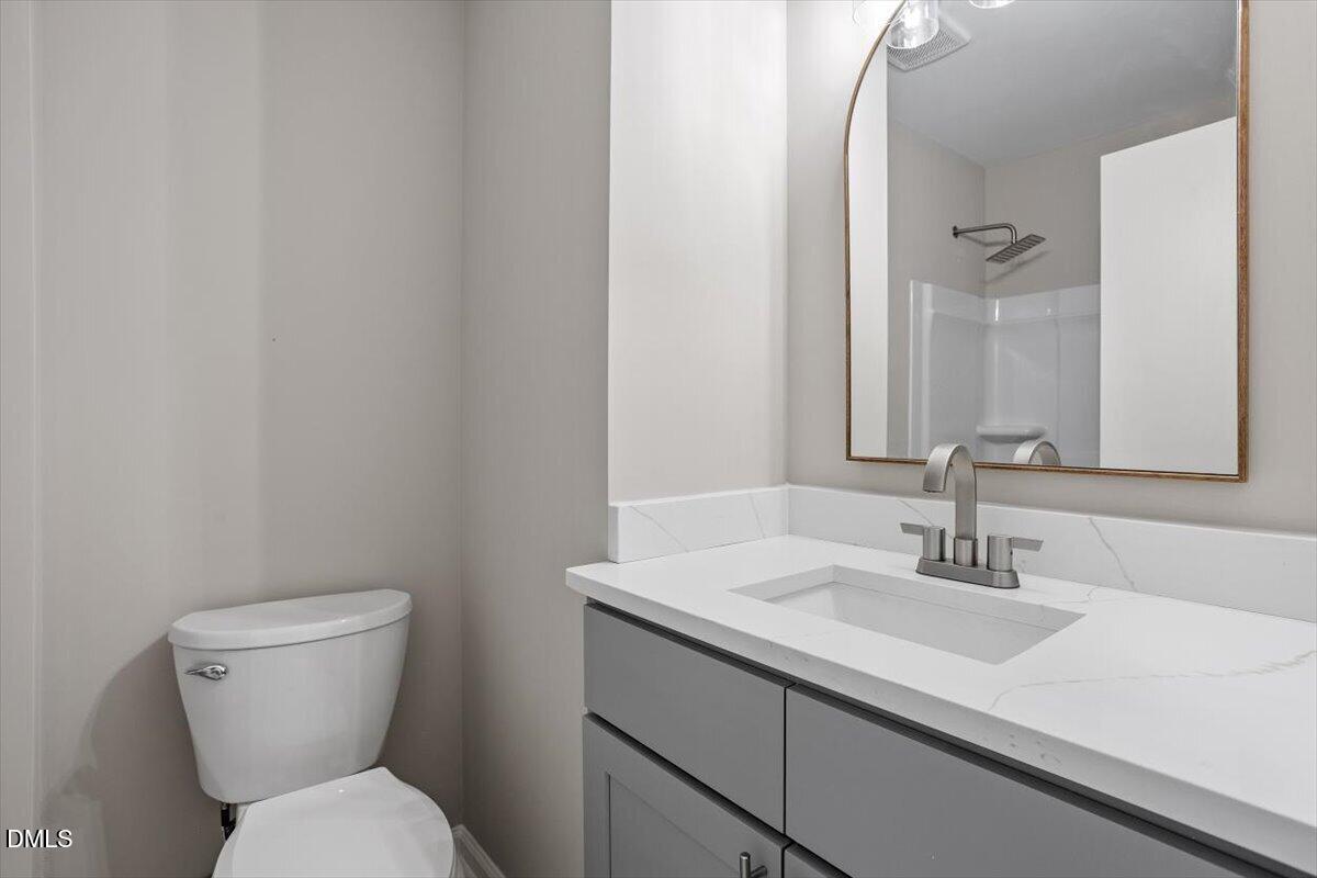 804 Little Rock Church Road Lucama, NC 27851 - Photo 23 of 28 a bathroom with a sink toilet and a mirror