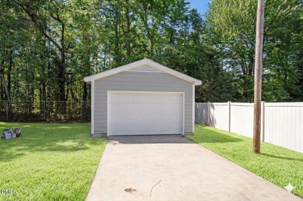 804 Little Rock Church Road Lucama, NC 27851 - Photo 28 of 28 a front view of a house with a yard and garage