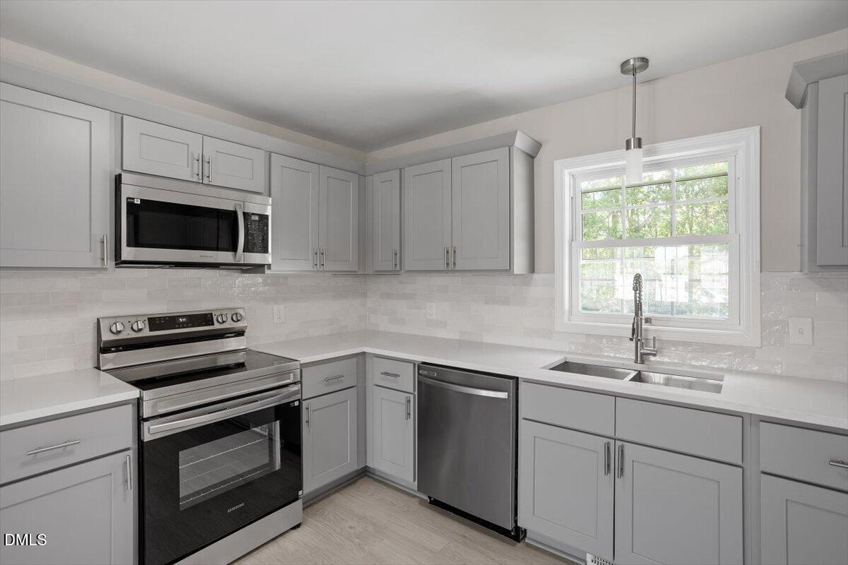 804 Little Rock Church Road Lucama, NC 27851 - Photo 3 of 28 a kitchen with a sink stove and microwave