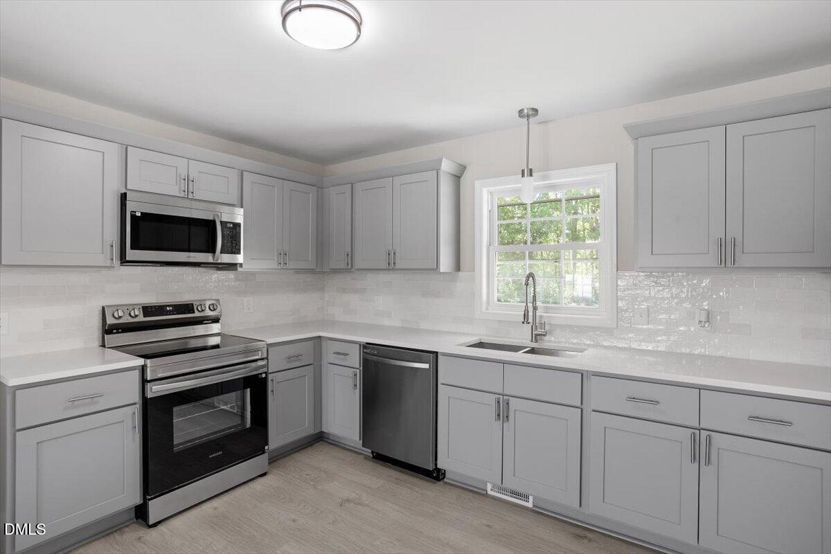 804 Little Rock Church Road Lucama, NC 27851 - Photo 5 of 28 a kitchen with appliances a sink and cabinets