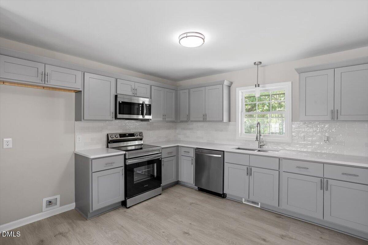 804 Little Rock Church Road Lucama, NC 27851 - Photo 6 of 28 a kitchen with sink a microwave and cabinets
