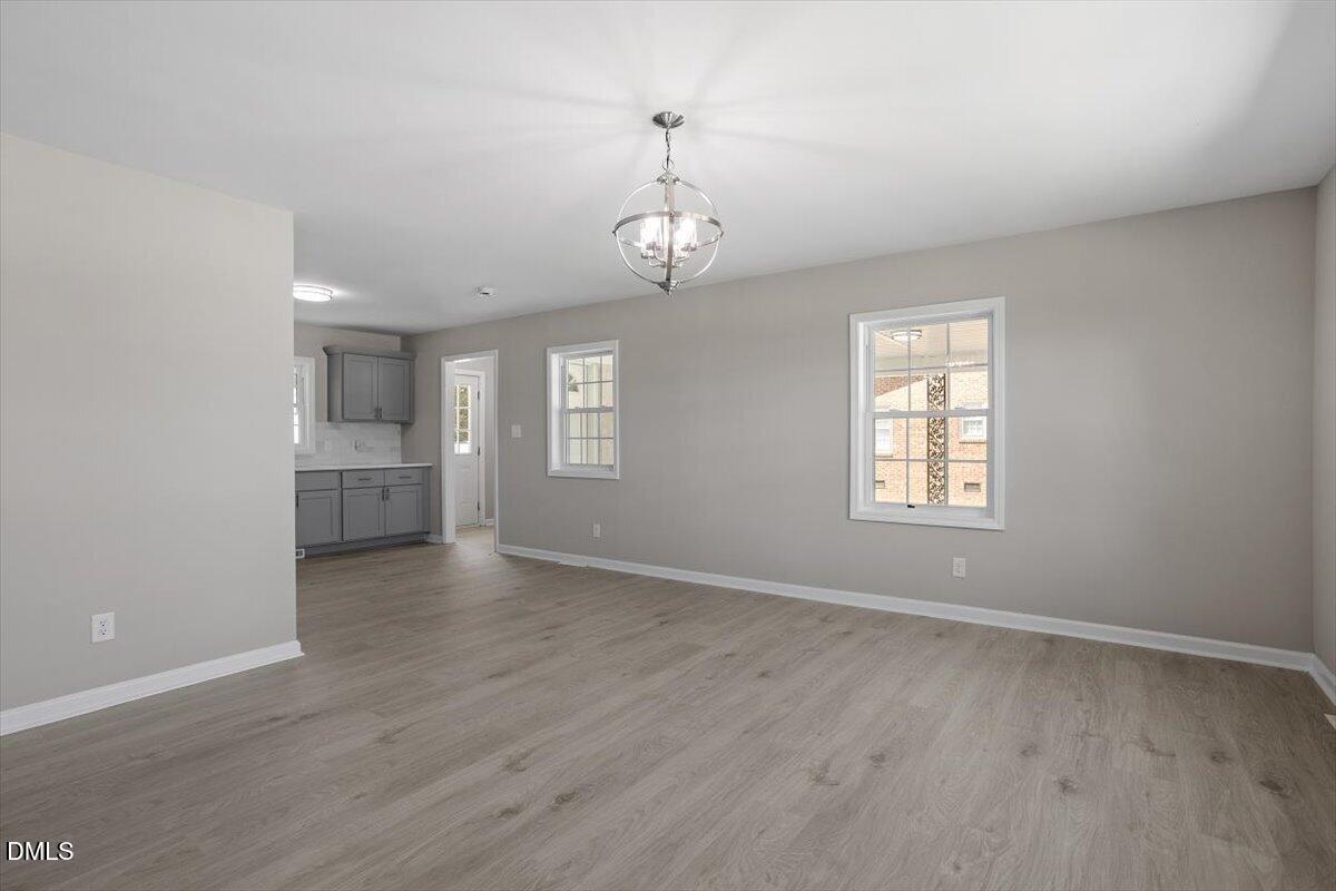 804 Little Rock Church Road Lucama, NC 27851 - Photo 8 of 28 wooden floor in an empty room with a window