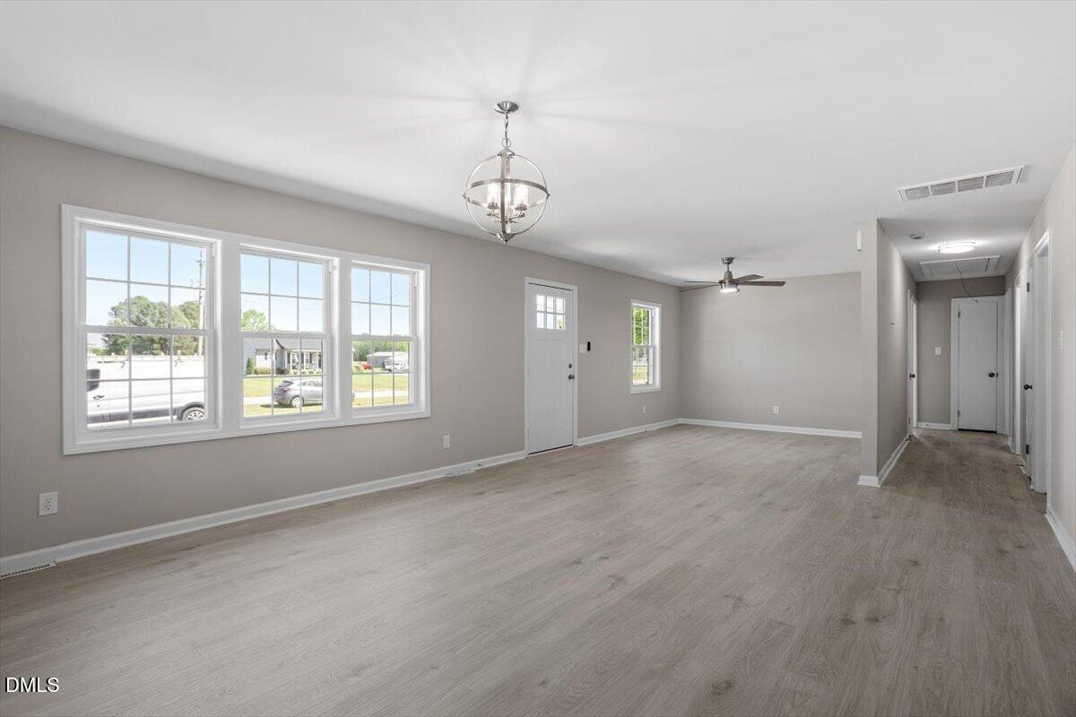 804 Little Rock Church Road Lucama, NC 27851 - Photo 10 of 28 a view of empty room with wooden floor and windows