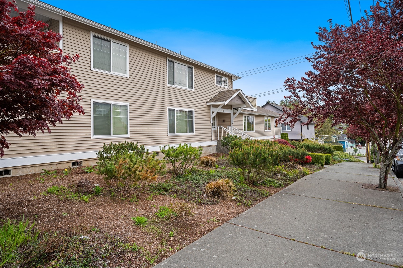 1516 33rd Street Everett, WA 98201 - Photo 4 of 9 a front view of a house with garden and trees