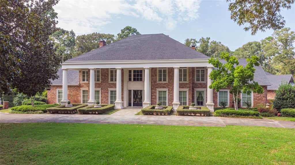 Greek revival house featuring a front lawn