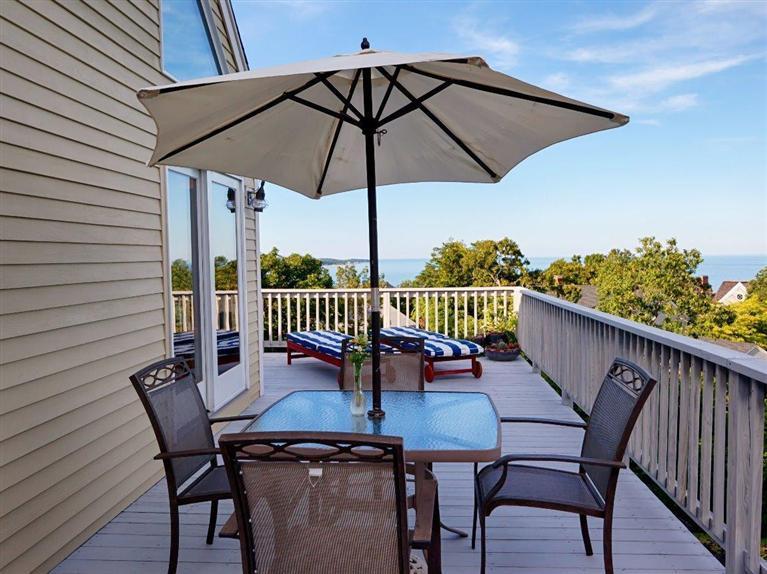 a view of balcony with furniture and umbrella